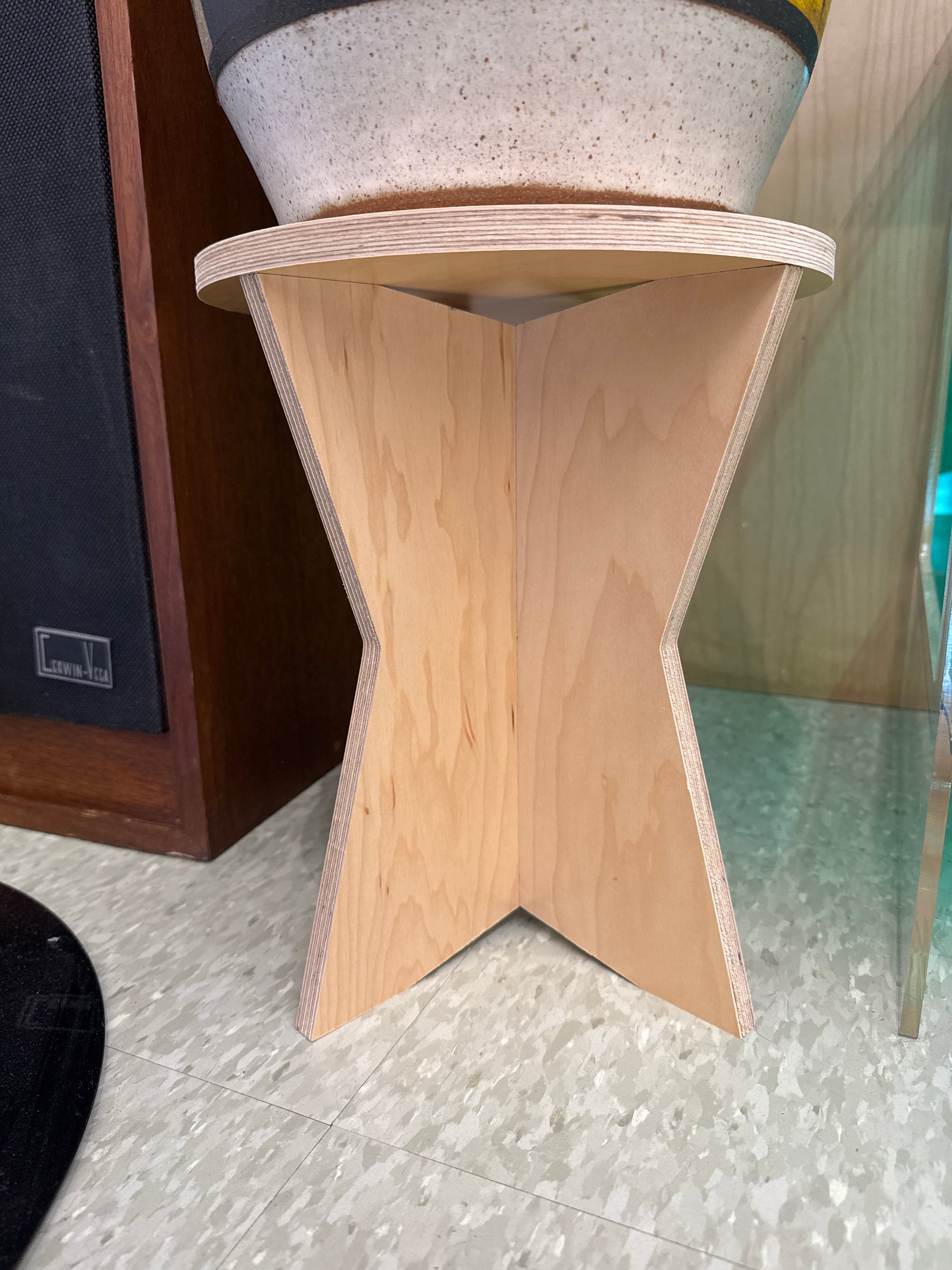 Wooden shelf with star-shaped cutout on a tiled floor